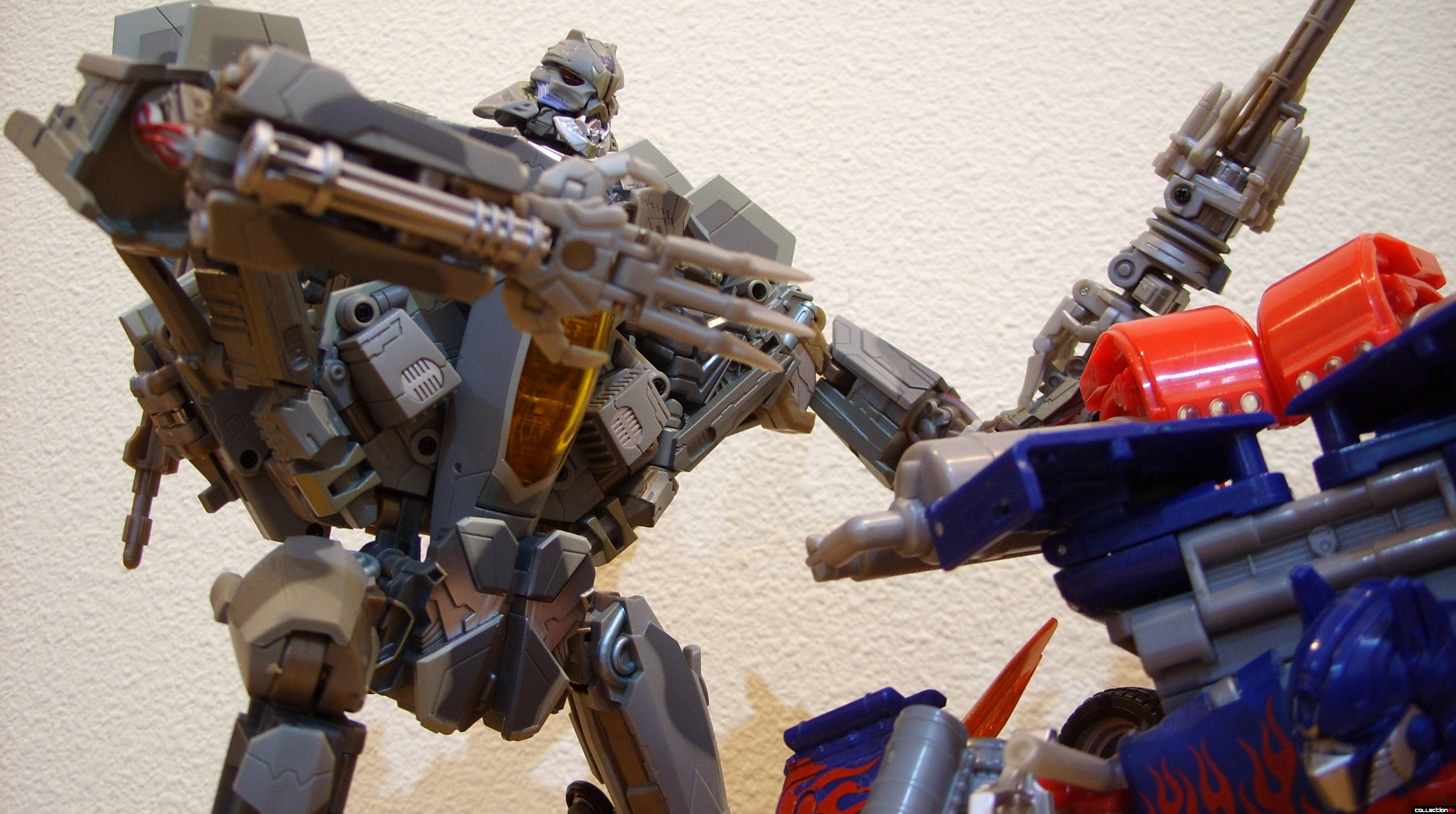 Masterpeice Movie Series Starscream- Robot Mode (L) posed with Leader-class Optimus Prime (R)
